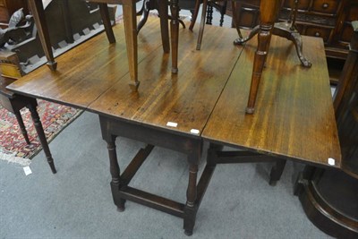 Lot 701 - A 19th century oak drop-leaf dining table