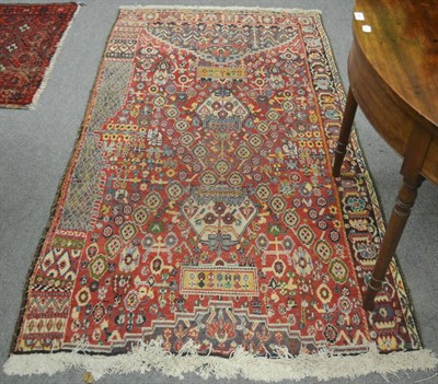 Lot 702 - Kashgai Wagireh rug, South West Persia, the raspberry field of tribal motifs and part...