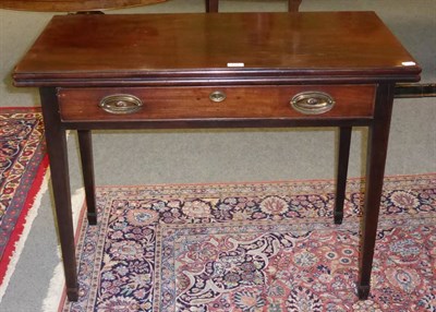 Lot 711 - A Georgian mahogany fold over tea table