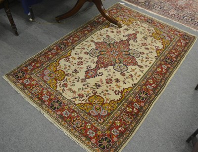 Lot 714 - Lahore rug, Punjab, the ivory field of floral vines centred by a crimson medallion framed by...