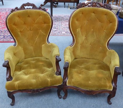 Lot 716 - A matched pair of late 19th century carved mahogany French armchairs upholstered in gold button...