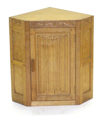 Lot 747 - Lizardman: A Derek Slater Panelled English Oak Hanging Corner Cupboard, with carved oak leaf...