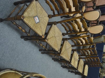 Lot 720 - A set of six rush seated ladder back chairs