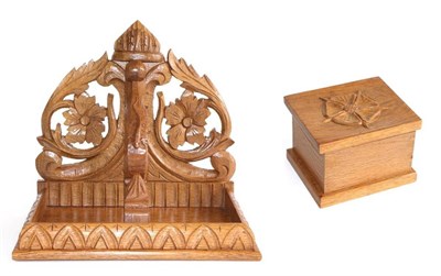 Lot 748 - Lizardman: A Derek Slater English Oak Wall Bracket, the rectangular top above a carved frieze...