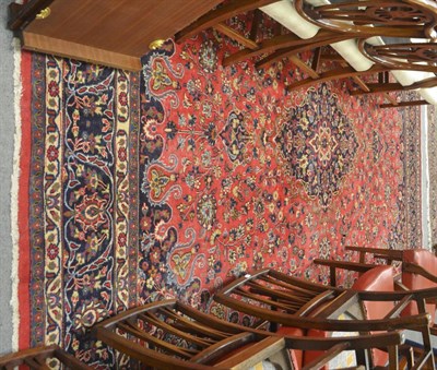 Lot 737 - A Khorasan carpet, North East Persia, the raspberry field of scrolling vines around a pole...