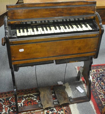 Lot 740 - Small oak and ebonised organ with two pedals