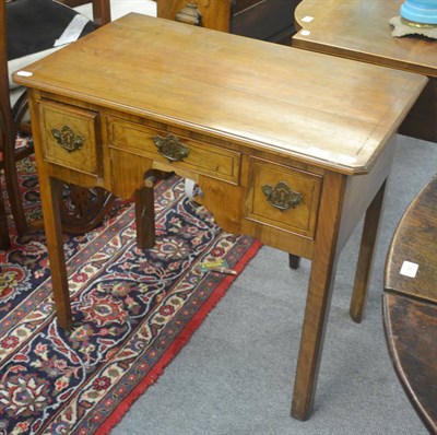 Lot 741 - A George III walnut low boy fitted with three drawers, 81cm wide