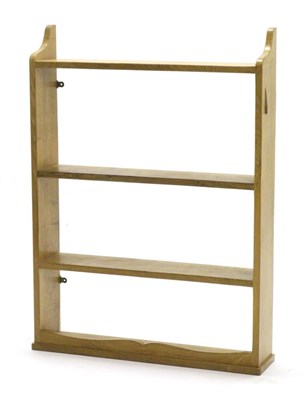 Lot 751 - Lizardman: A Derek Slater English Oak Hanging Open Book Shelf, shaped top rail, three shelves,...