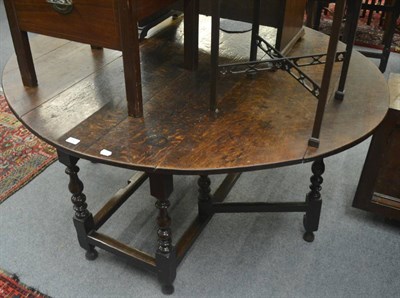 Lot 759 - An early 18th century six seater gate leg table fitted a frieze drawer