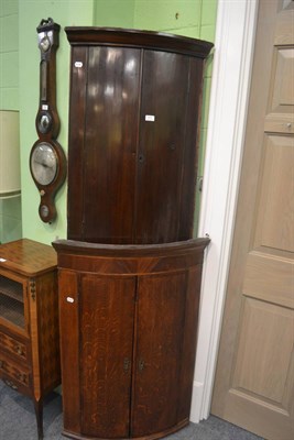 Lot 771 - Georgian oak bow front corner cabinet and a mahogany example