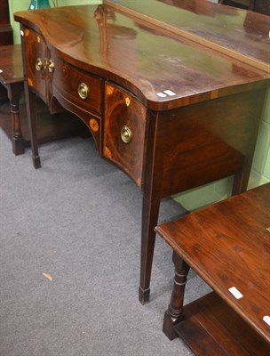 Lot 775 - A George III mahogany serpentine shaped sideboard