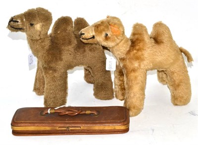 Lot 56 - Two Camel soft toys with exaggerated humps, button eyes and stitched noses, 27cm high by 27cm wide