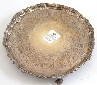 Lot 80 - A George II silver salver, Henry Morris, London 1741, raised on three volute feet, the centre...