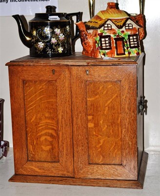 Lot 92 - A smokers cabinet and two teapots