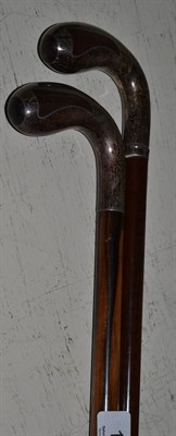 Lot 108 - Two hardwood walking sticks with overlaid silver handles, each with a monogram and titled SALTBURN