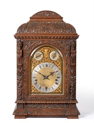 Lot 778 - A Carved Oak Chiming Table Clock, circa 1890, elaborately carved case with scroll, floral and...