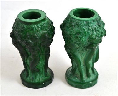 Lot 127 - A matched pair of green glass figural vases