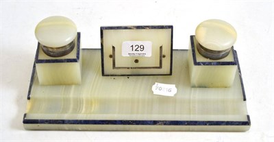 Lot 129 - An silver mounted onyx inkstand with two inkwells, void for a calendar and a pen tray