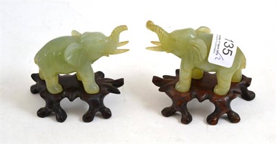 Lot 135 - Pair of green hardstone elephants on hardwood stands