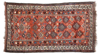 Lot 788 - Luri Carpet West Iran, circa 1930 The madder field with columns of hooked güls enclosed by...