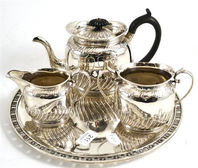 Lot 211 - A silver three piece tea service and a French silver tray (4)