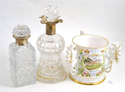 Lot 223 - A silver mounted decanter, another and a commemorative china tyg