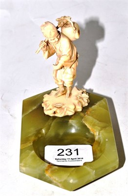 Lot 231 - A Japanese ivory figure mounted on an onyx ashtray, circa 1900