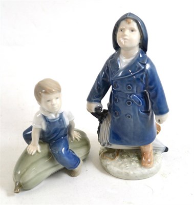 Lot 252 - Royal Copenhagen boy with umbrella 3556 and Royal Copenhagen boy on a gourd 4539