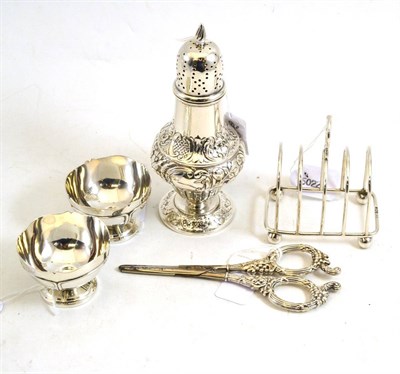 Lot 255 - Edwardian embossed silver sugar caster, Chester 1902, wire toast rack, pair of small bowls and...