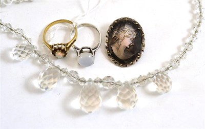 Lot 262 - An opal and garnet ring, a moonstone ring, a cameo and a glass necklace