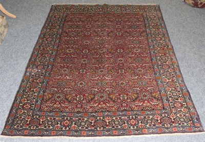 Lot 795 - Tabriz Rug Iranian Azerbaijan, circa 1940 The madder lattice field of flowerheads and serrated...