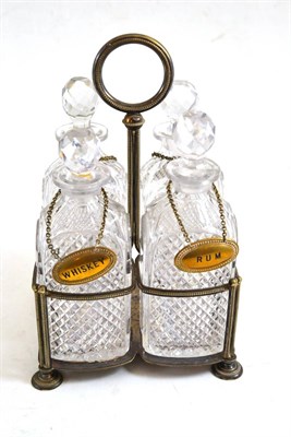 Lot 327 - A silver plated four bottle decanter stand with a set of four cut glass decanters with plated...