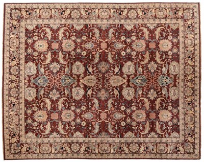 Lot 806 - Indian Carpet, late 20th century The chestnut field with an allover design of large flowerheads...