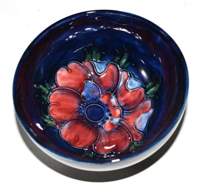 Lot 387 - A Walter Moorcroft Anemone pattern bowl, on a blue ground, printed label, 11cm diameter