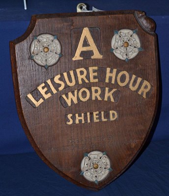 Lot 393 - A Robert ";Mouseman"; Thompson oak shield, carved with three Yorkshire white painted roses,...