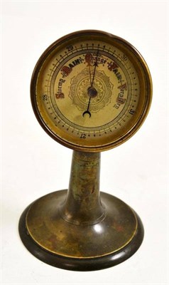 Lot 399 - A brass binnacle form aneroid desk barometer