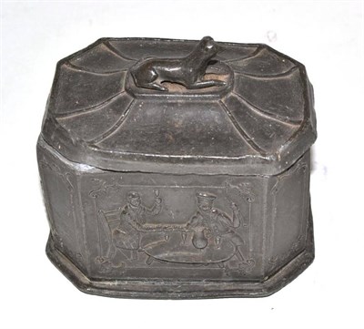 Lot 438 - A 19th century lead tobacco box, cover and inner lid decorated with figures smoking church...