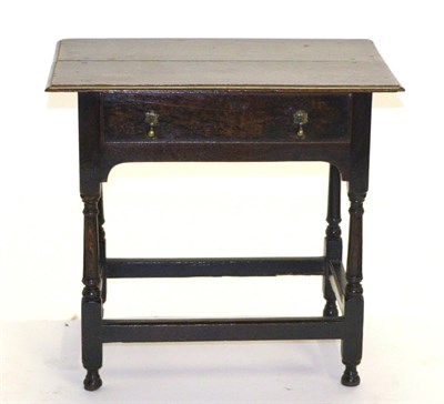 Lot 822 - An Early 18th Century Oak Side Table, with a single frieze drawer above an arched apron, raised...