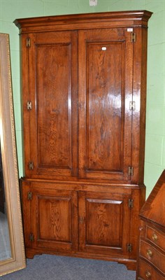 Lot 531 - A reproduction oak floor standing corner cupboard