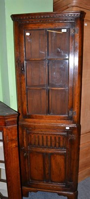 Lot 535 - A reproduction oak glazed corner cabinet on stand by Titchmarsh & Goodwin