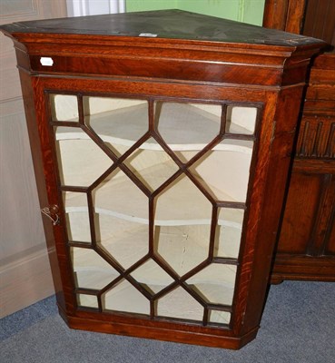 Lot 536 - An astragal glazed oak corner cabinet