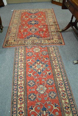 Lot 537 - Narrow runner of Caucasian design, North Afghanistan, the blood red field with a column of...