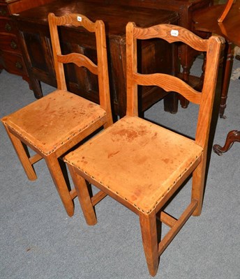 Lot 546 - A set of four Kingpost woodwork oak chairs, with shaped rail backs, on four square section legs...