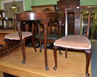 Lot 548 - Mahogany oval table with volute feet and a pair of chairs