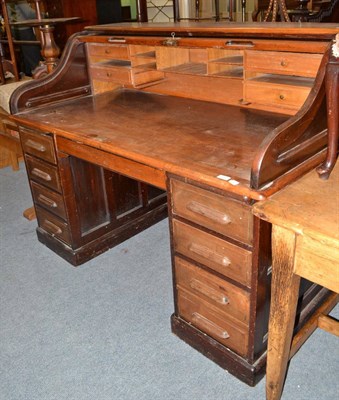 Lot 550 - An oak tambour desk