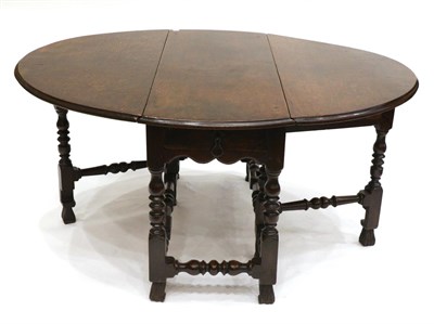 Lot 831 - A 17th Century Joined Oak Six-to-Eight Seater Gateleg Dining Table, with two drop leaves to form an