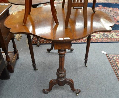 Lot 553 - A Victorian walnut Sutherland table with shaped top and carved legs