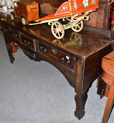 Lot 571 - An early 18th century oak dresser base, lacking rack