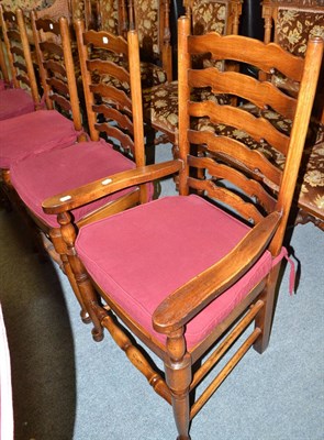 Lot 582 - A set of six reproduction ladder back dining chairs