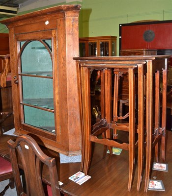 Lot 613 - A nest of tables and an oak corner cupboard